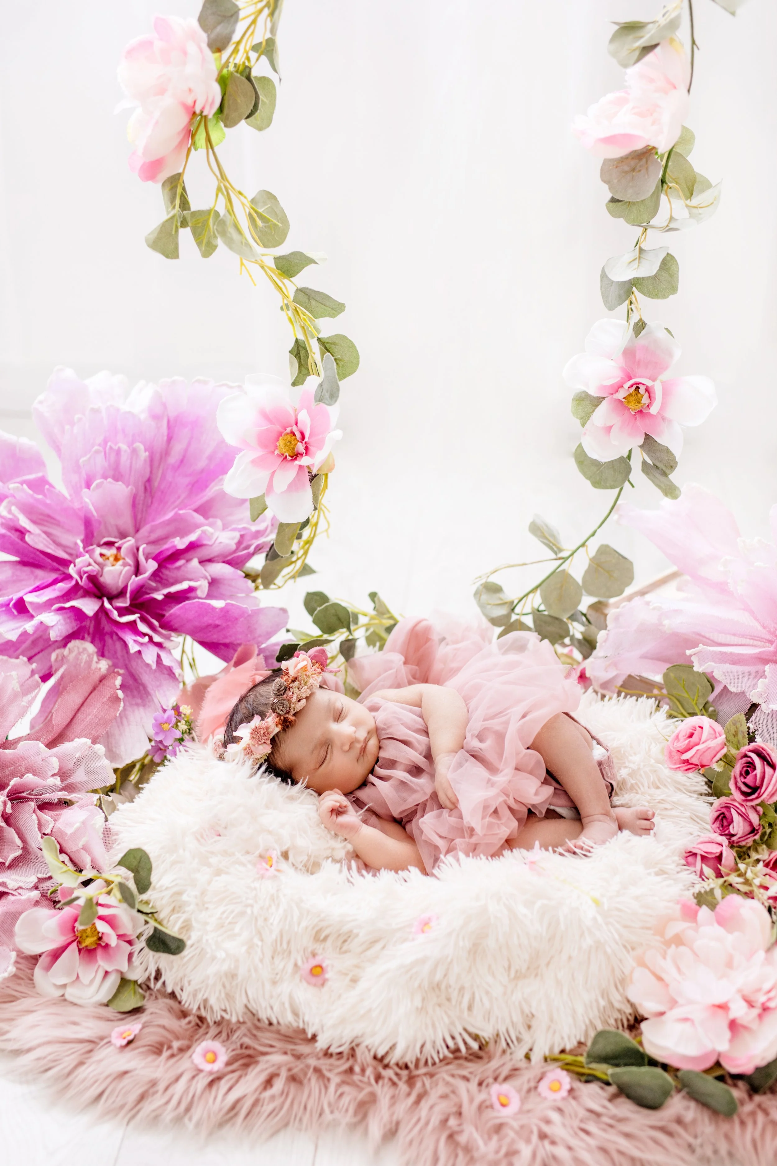 Newborn girl in floral setup during luxury photography session in Mississauga"