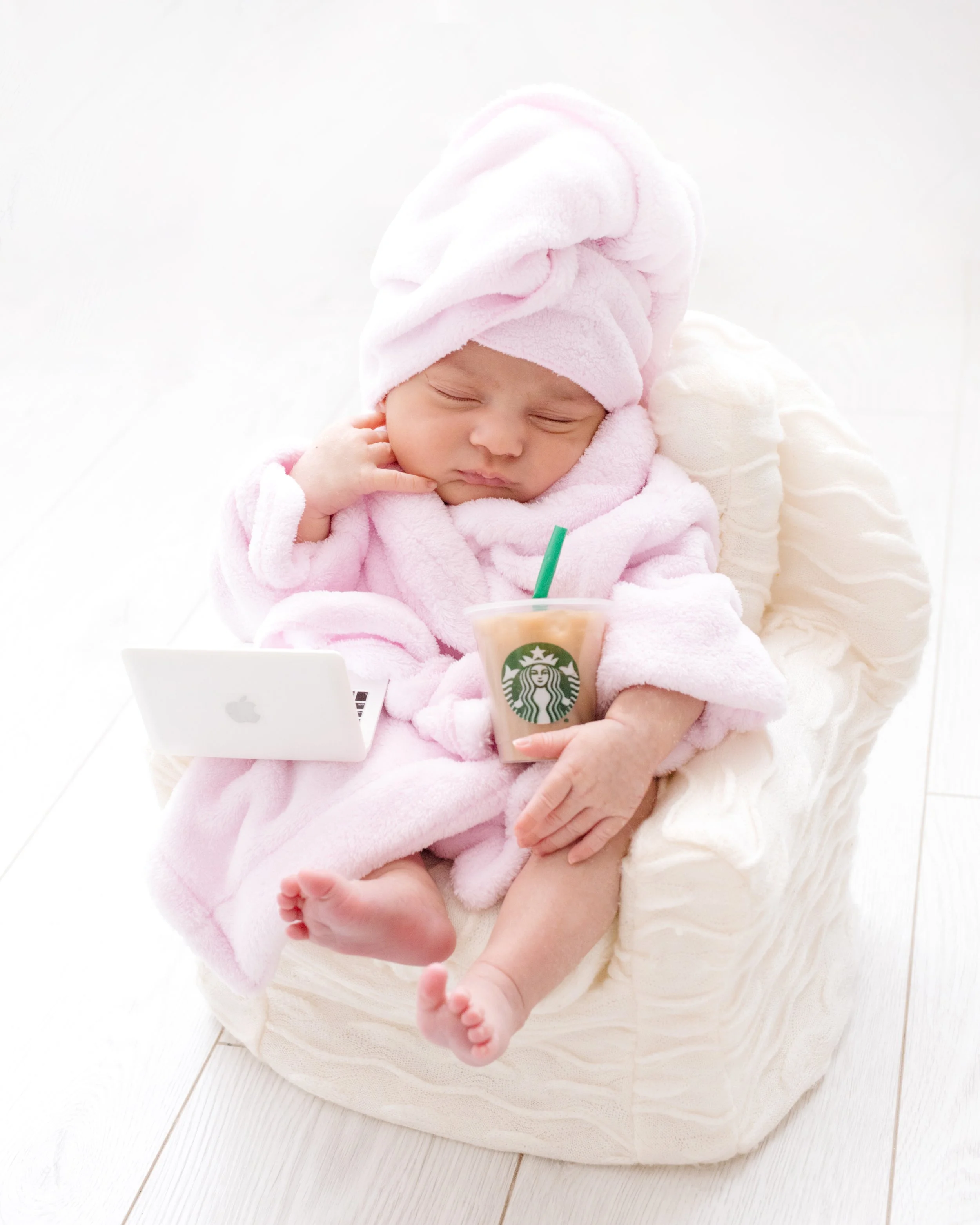 Newborn girl in robe setup during luxury photography session in Mississauga