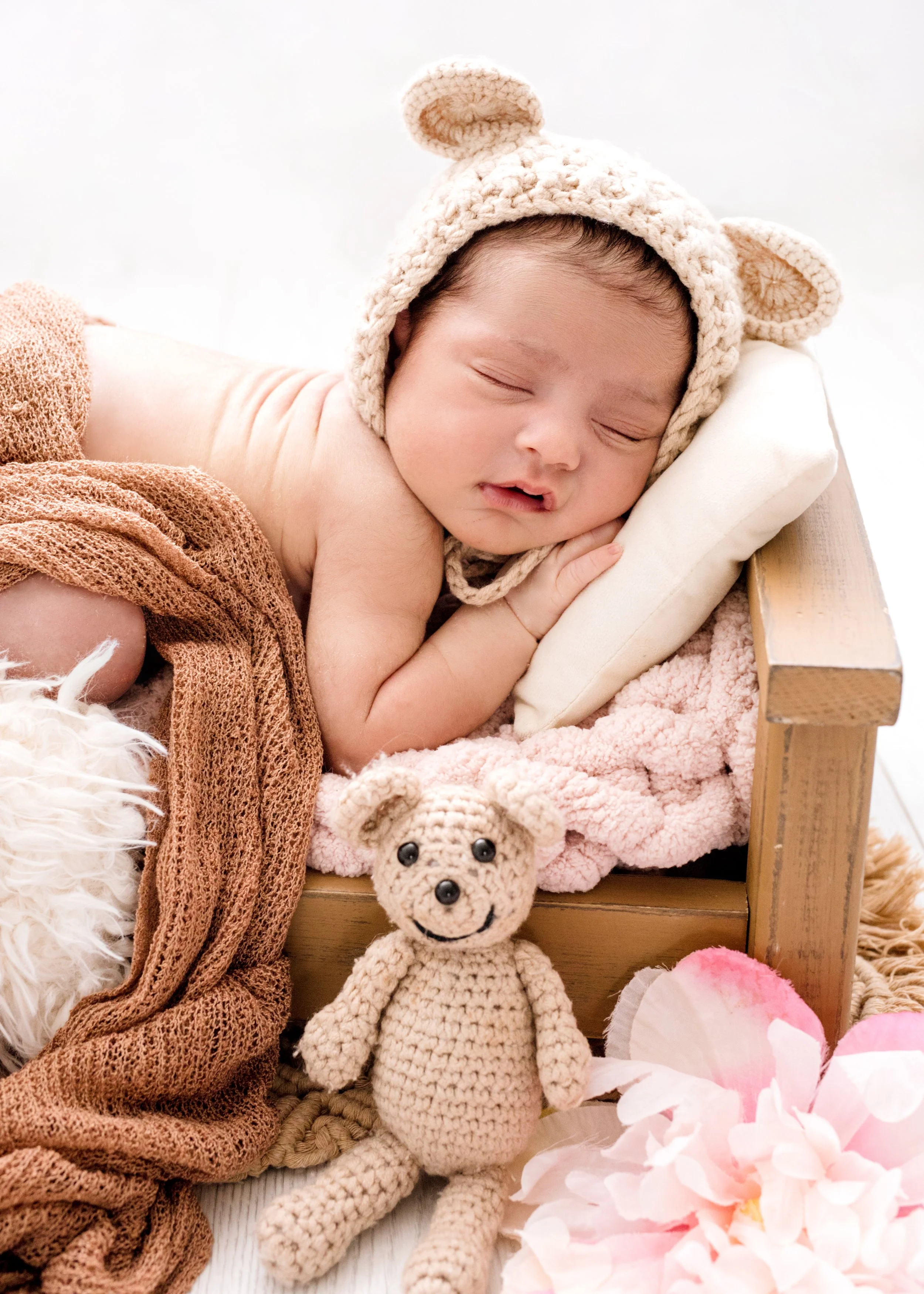 Newborn girl in tiny bed setup during luxury photography session in Mississauga