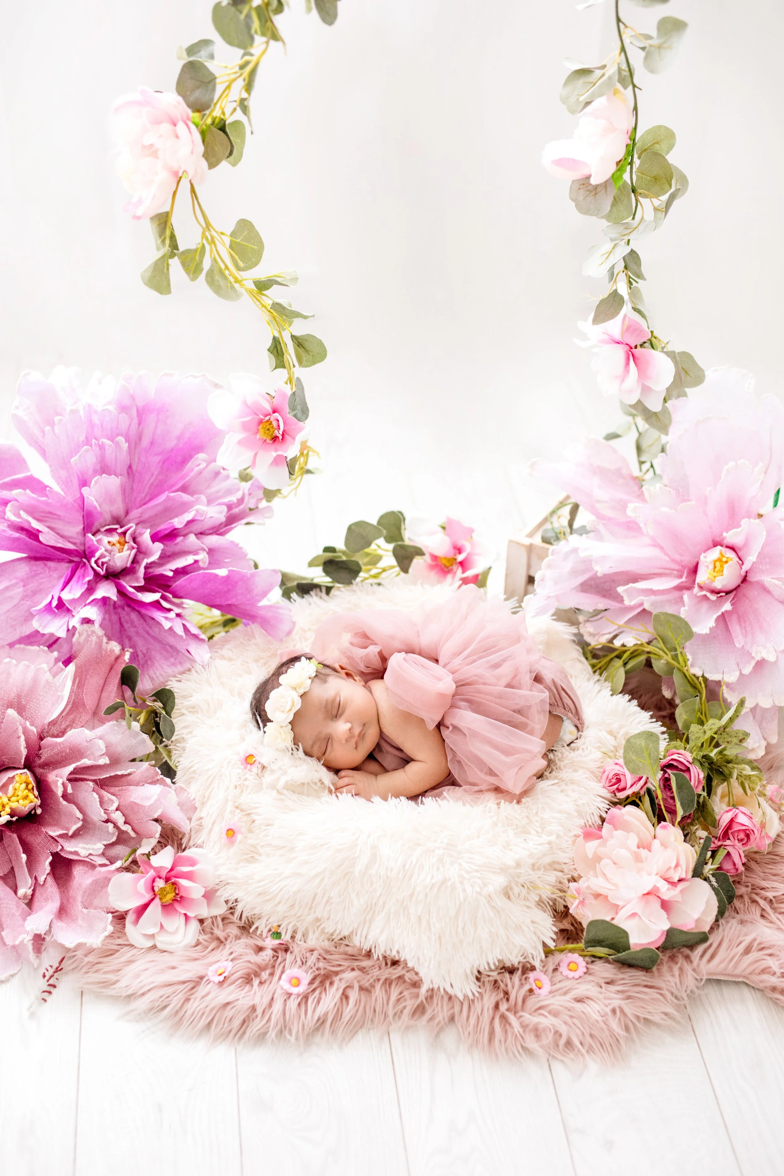 Newborn girl in floral setup during luxury photography session in Mississauga"