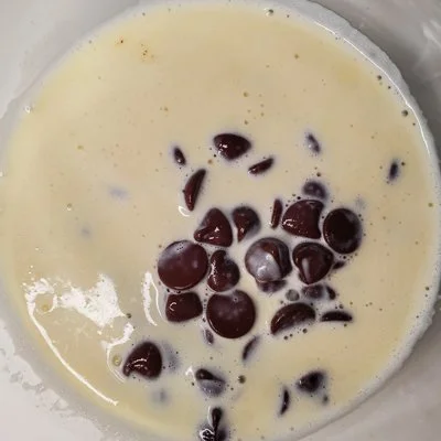 chocolate chips in a cream mixture before being mixed into ganache