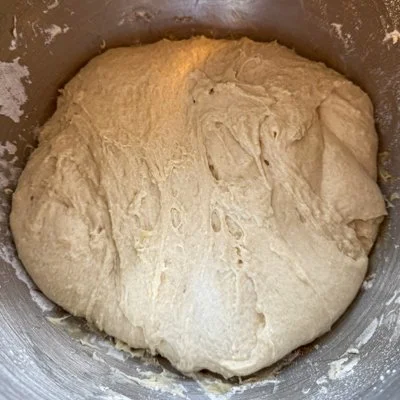 focaccia dough in a metal mixing bowl