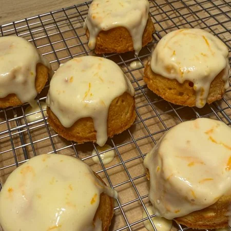 iced carrot and orange tea cakes on a wire cooling rack