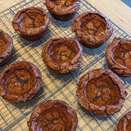 baked brownie cups on a wire cooling rack