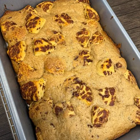 baked banana bread cinnamon roll bake in a metal baking pan