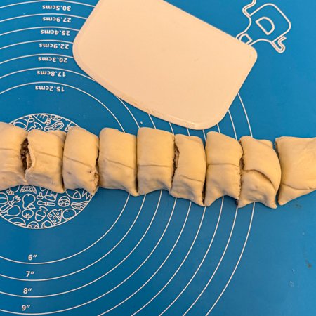 rolled up puff pastry dough with maple pecan filling cut into slices