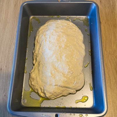 focaccia dough in a metal baking pan