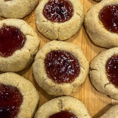 close up of plum cardamom thumbprint cookies