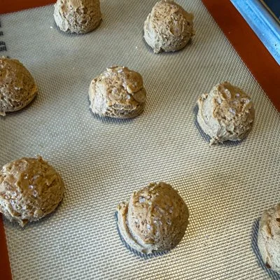 honey peanut butter cookie dough balls on a baking sheet