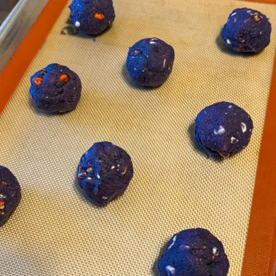 balls of Halloween kitchen sink cookie dough on a baking sheet