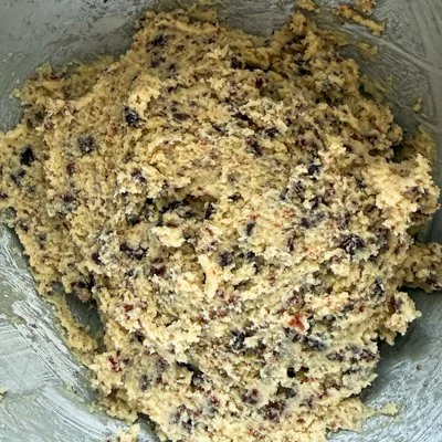 cherry chocolate almond cookie dough in a mixing bowl