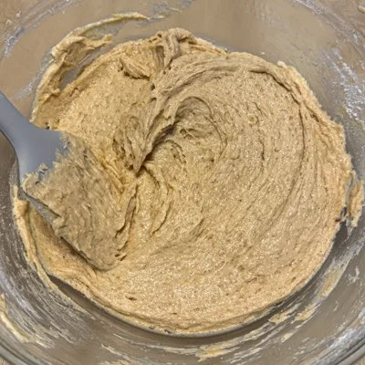 banana bread batter in a metal mixing bowl