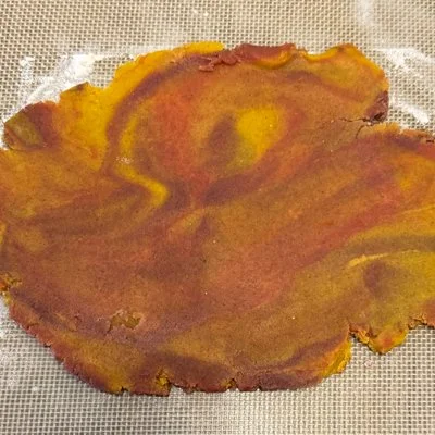 multicolor swirled cookie dough rolled into a thin sheet