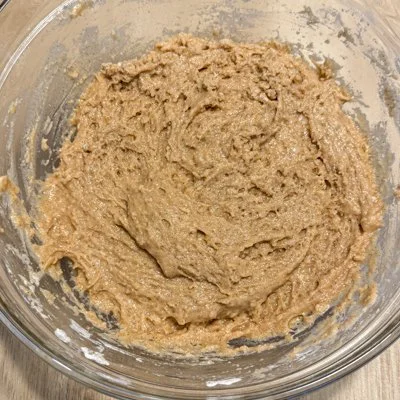apple cider donut batter in a glass mixing bowl