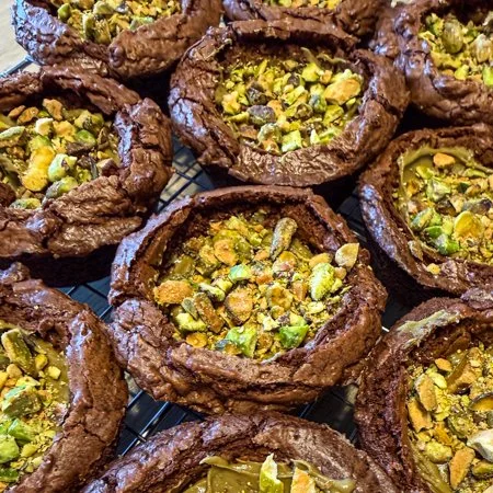 overhead shot of pistachio brownie cups on a wire cooling rack