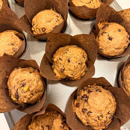 baked peanut butter, date, and banana muffins in a muffin pan