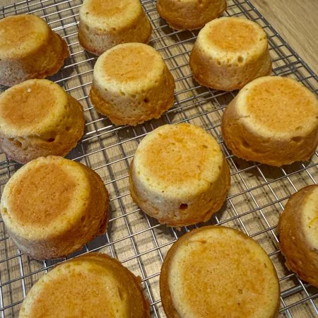 carrot and orange mini cakes on a wire cooling rack