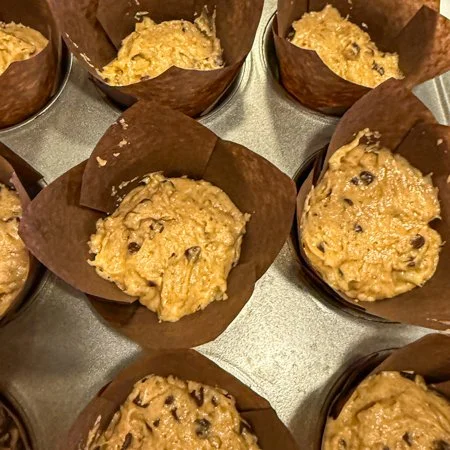 peanut butter, data, and banana muffin batter in muffin liners
