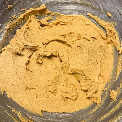 honey peanut butter cookie dough in a metal mixing bowl