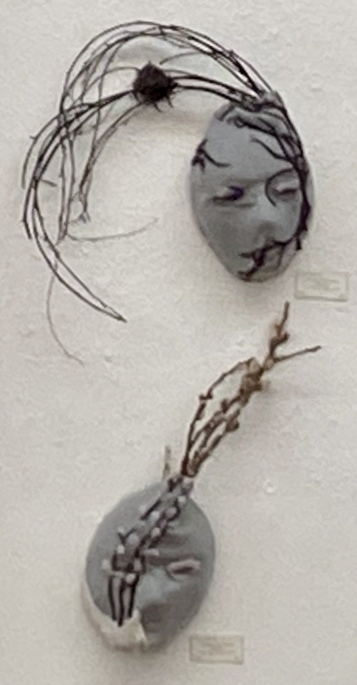 Art wall installation by Lucca Etienne: 2 face masks in gray