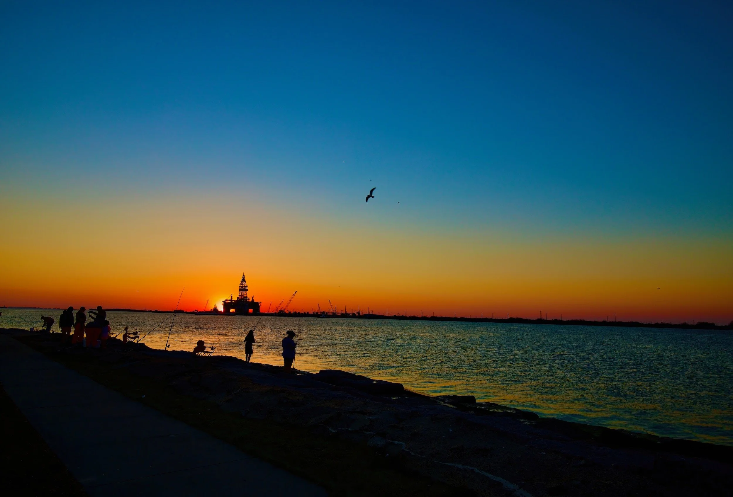 " Last Cast " Anglers silhouetted against a colorful sunset in Port , Aransas, Texas