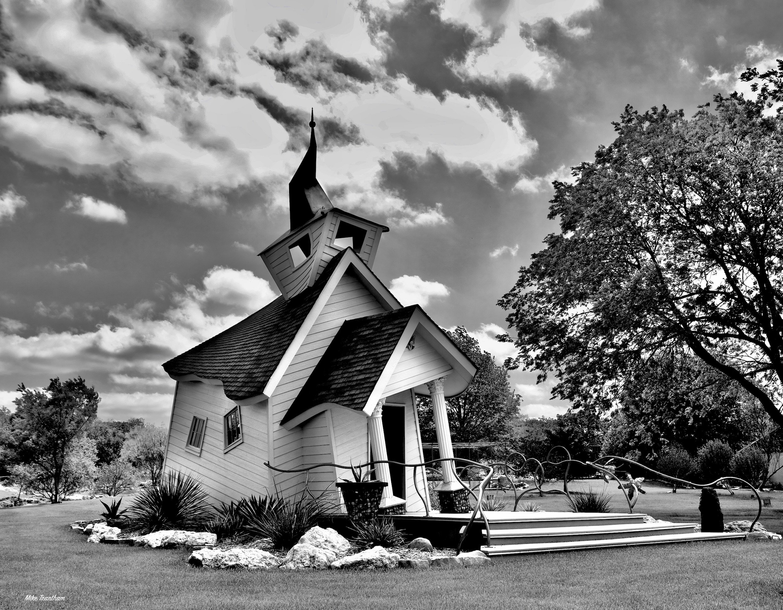  " Twisted Chapel "  Black-and-white photo of the whimsical Twisted Chapel in Texas,  unusual architecture looks  surreal .