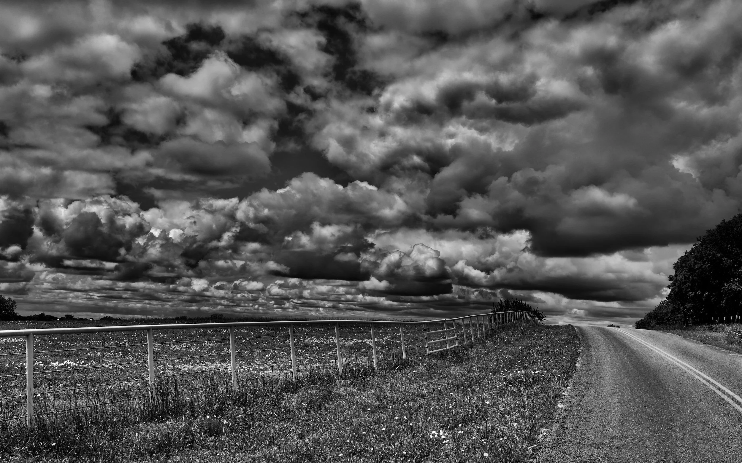 " Road to Thunder " A lonely country road disappears beneath a vast, turbulent sky of clouds.