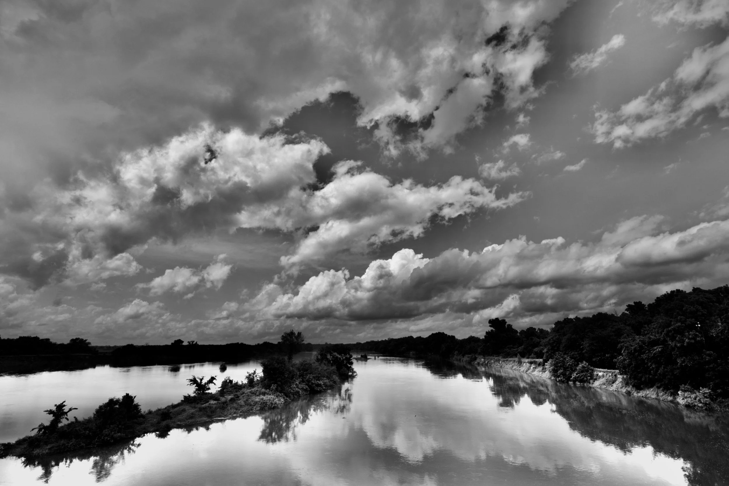 " Mirror Sky " Dramatic clouds reflected on the Red River near Carpenters Bluff in black-and-white.