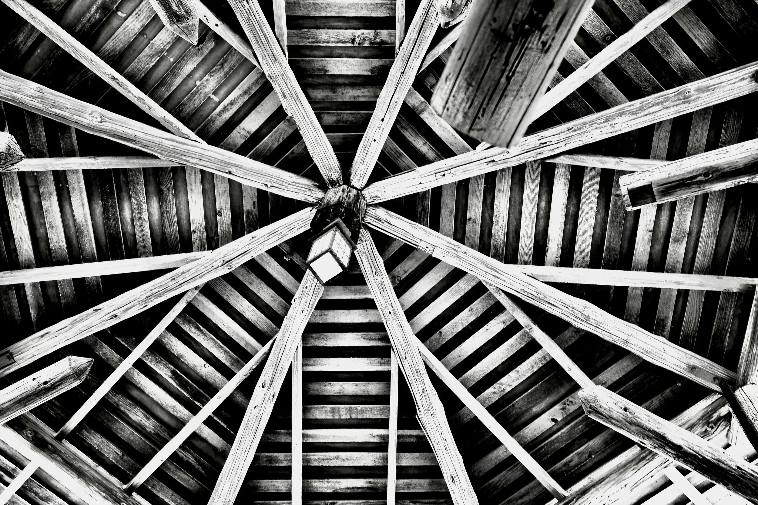 " Wooden Galaxy "   Historic roof rafters creating dramatic geometric patterns in black-and-white fine art photography.