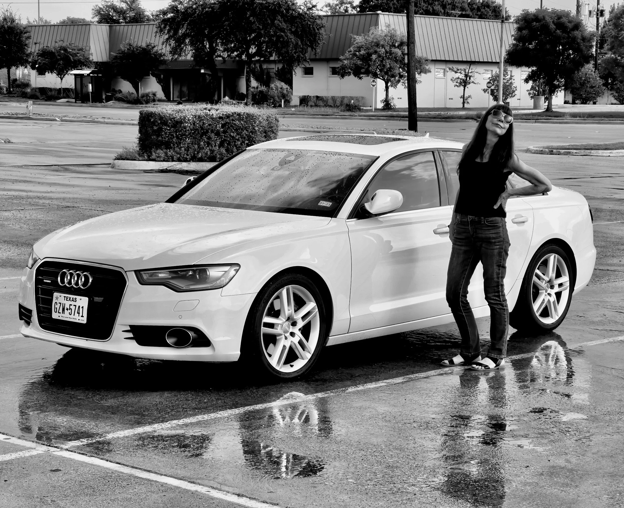  " One More Look at the Rain " pretty women beside luxury sedan after a Texas rainstorm.