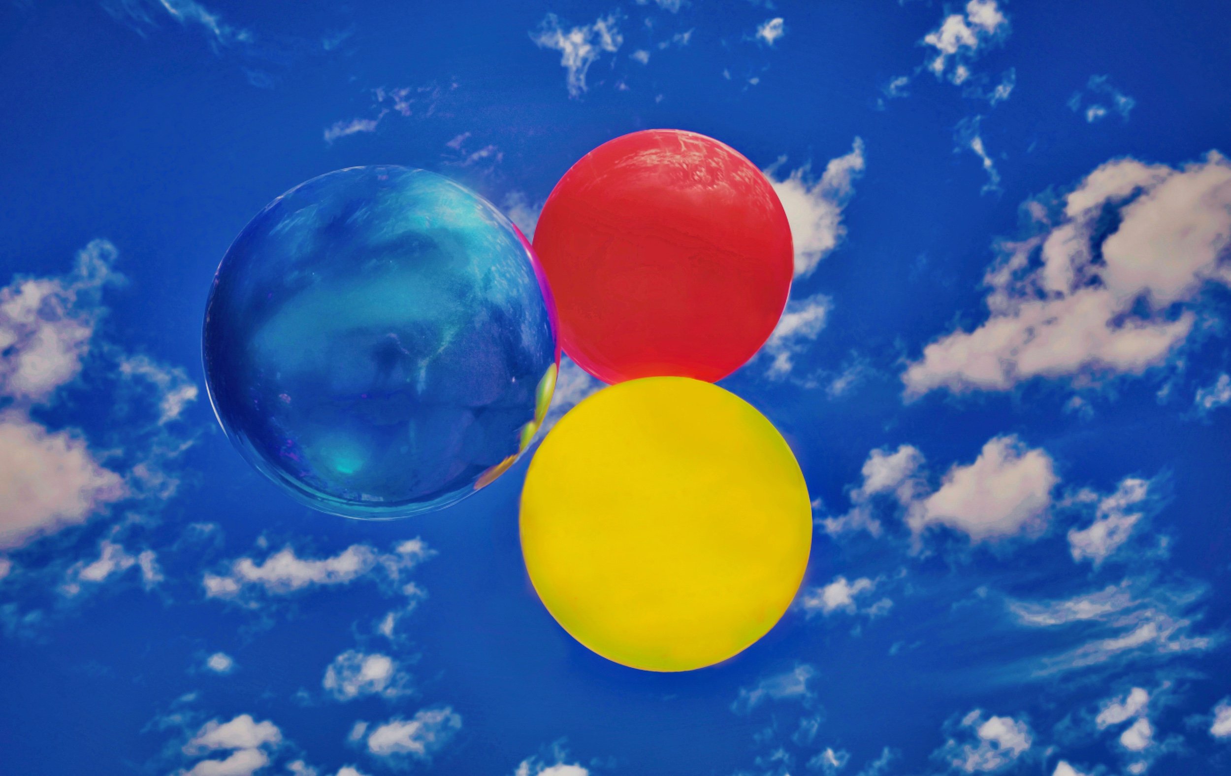 " Primary Orbit " Three vibrant spheres drift through endless  blue, transforming  into contemporary  fine art.