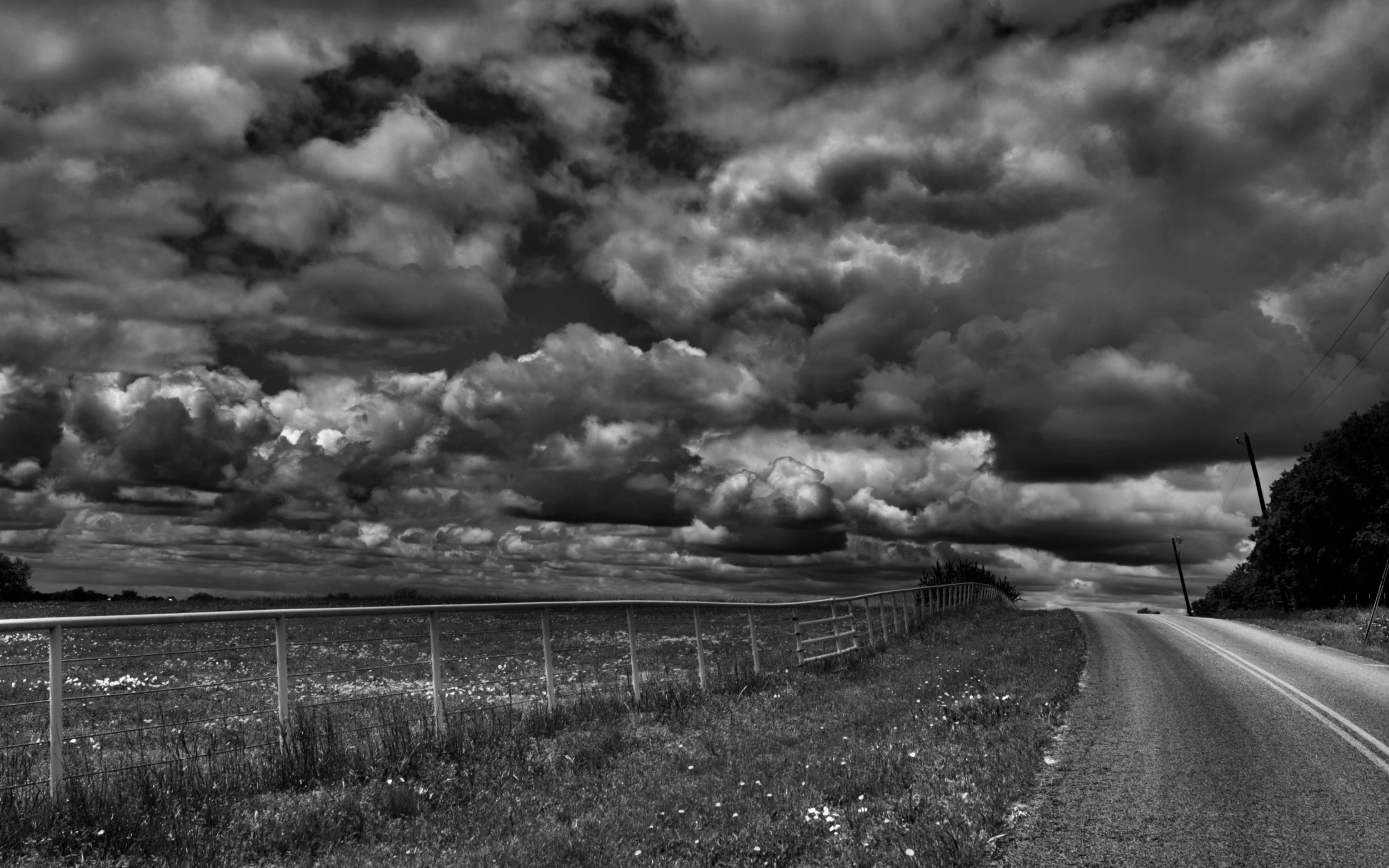 " Under Heavy Skies "  Dramatic Texas cloudscape above a rural road in black-and-white photography
