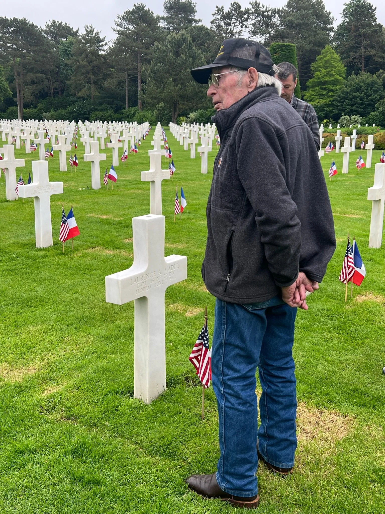 Bill visiting the gravesite of Capt Lawrence Madill, who died during the Normandy landings.