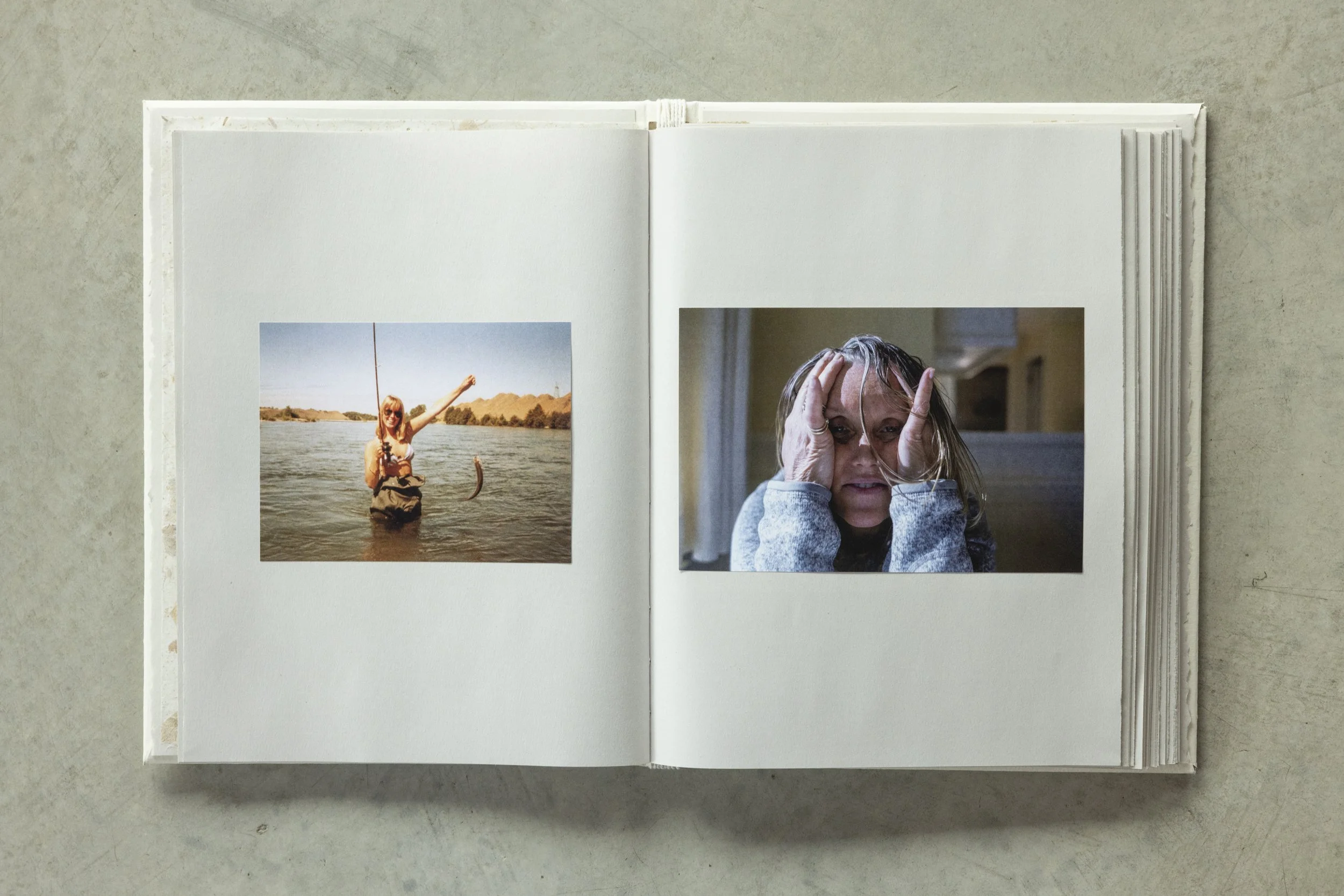 Open photo album showing two photographs: one of a woman standing in a river holding a fish, and another of a woman indoors with wet hair holding her hands to her face.