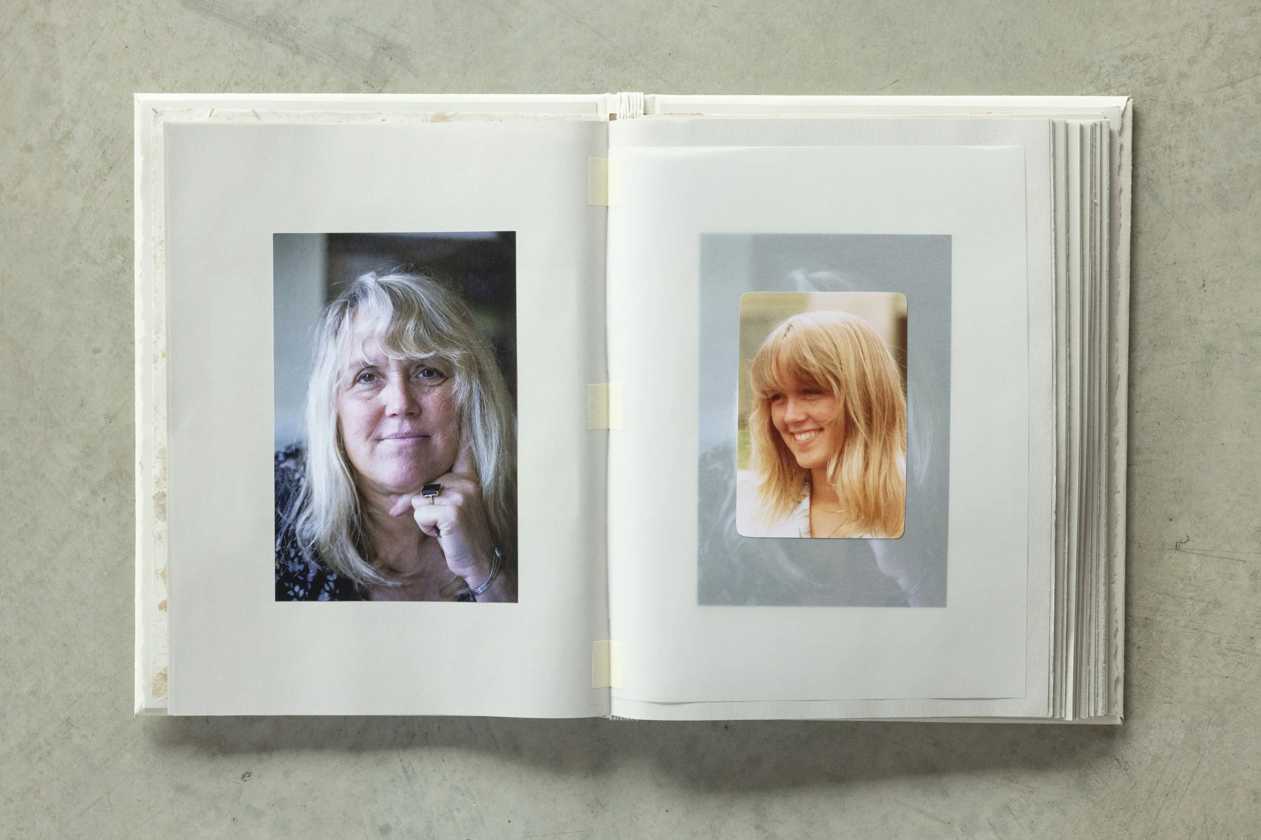 Open photo album showing two portraits of women with blond hair. The woman on the left has shoulder-length hair and is looking directly at the camera; the woman on the right has long hair and is smiling slightly.