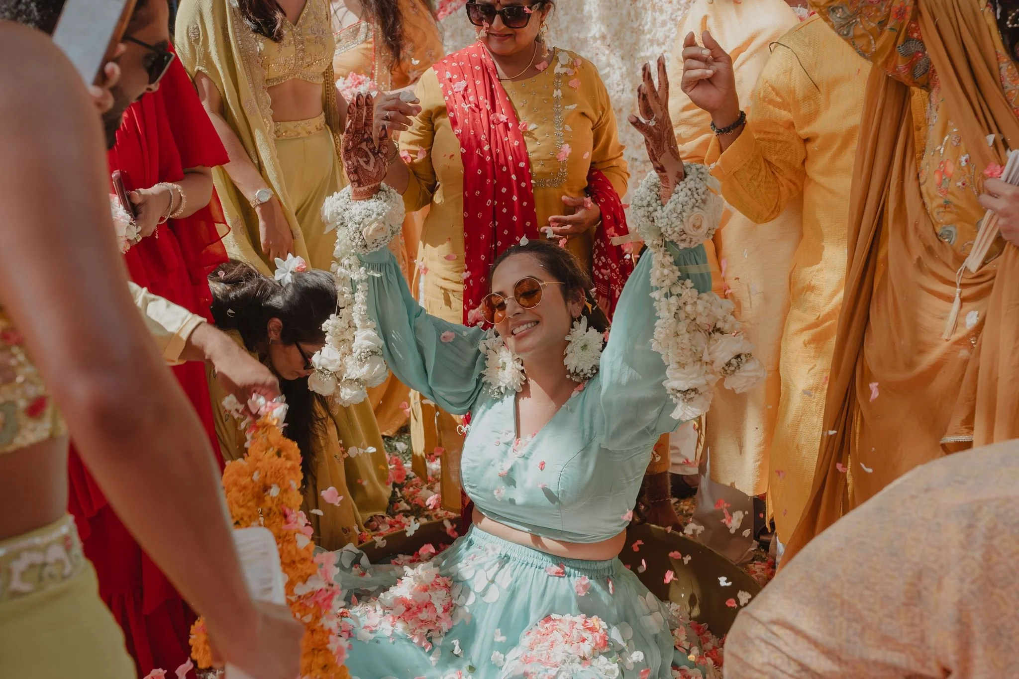 Family showering the bride with flower petals during a Flower Haldi in Bali