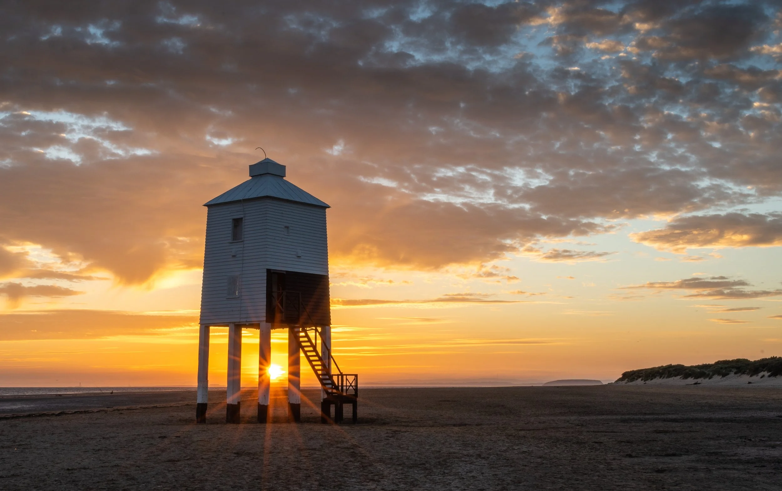 Starburst of light through the legs of Burnham on Sea Low Lighthouse, Somerset.