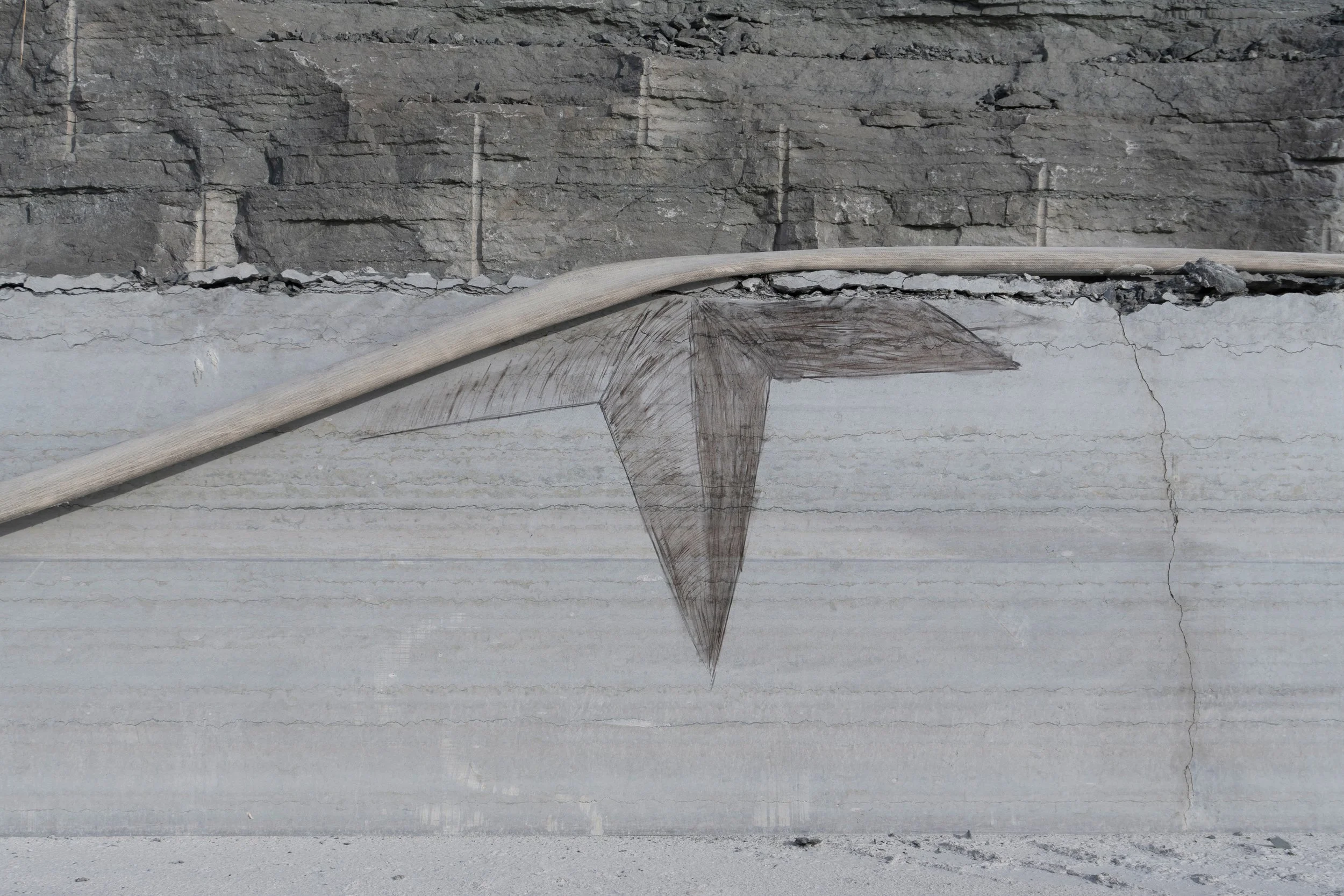 In the Bag of Stars (IV). Detail. 
Water hose and found fire coal on quarry wall. 
