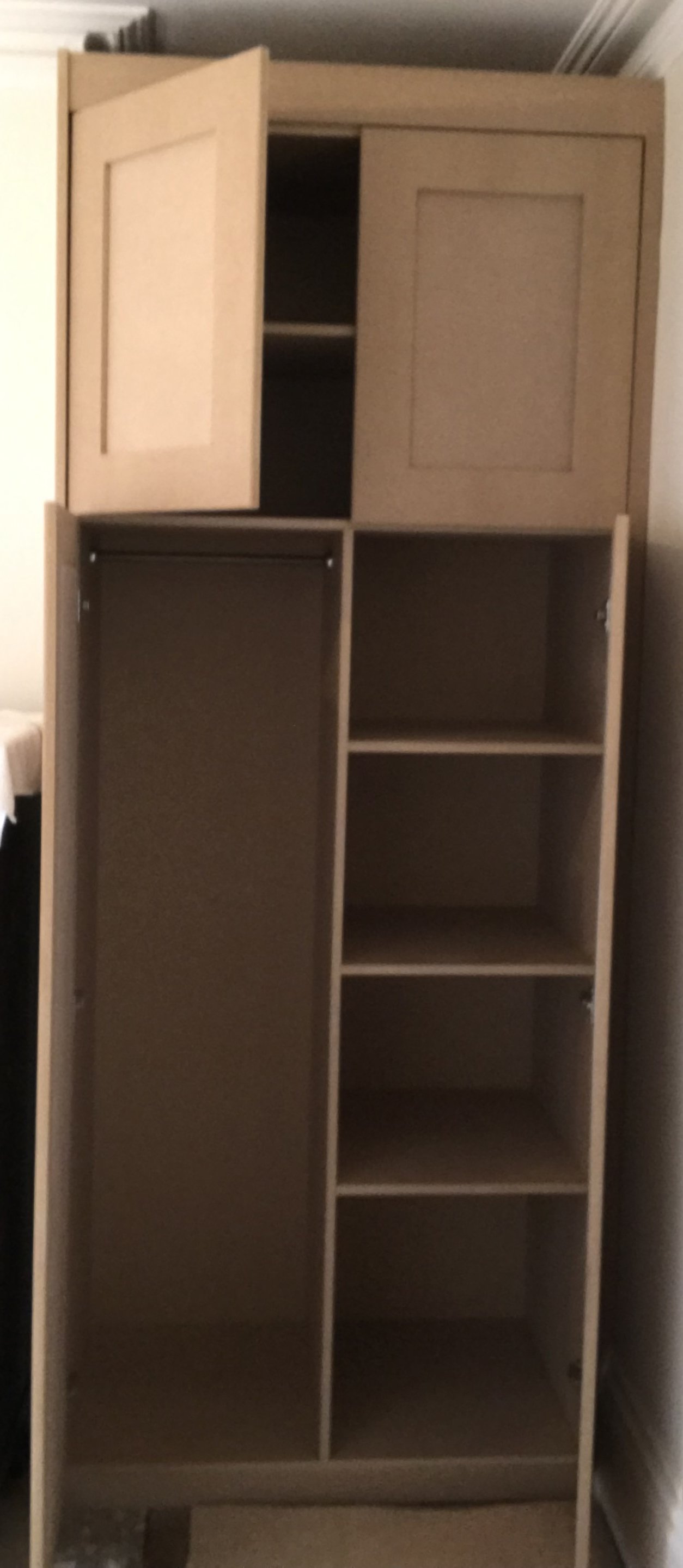 A tall wooden cabinet with open and closed storage sections, featuring a small cabinet on top with two doors and multiple open shelves below.