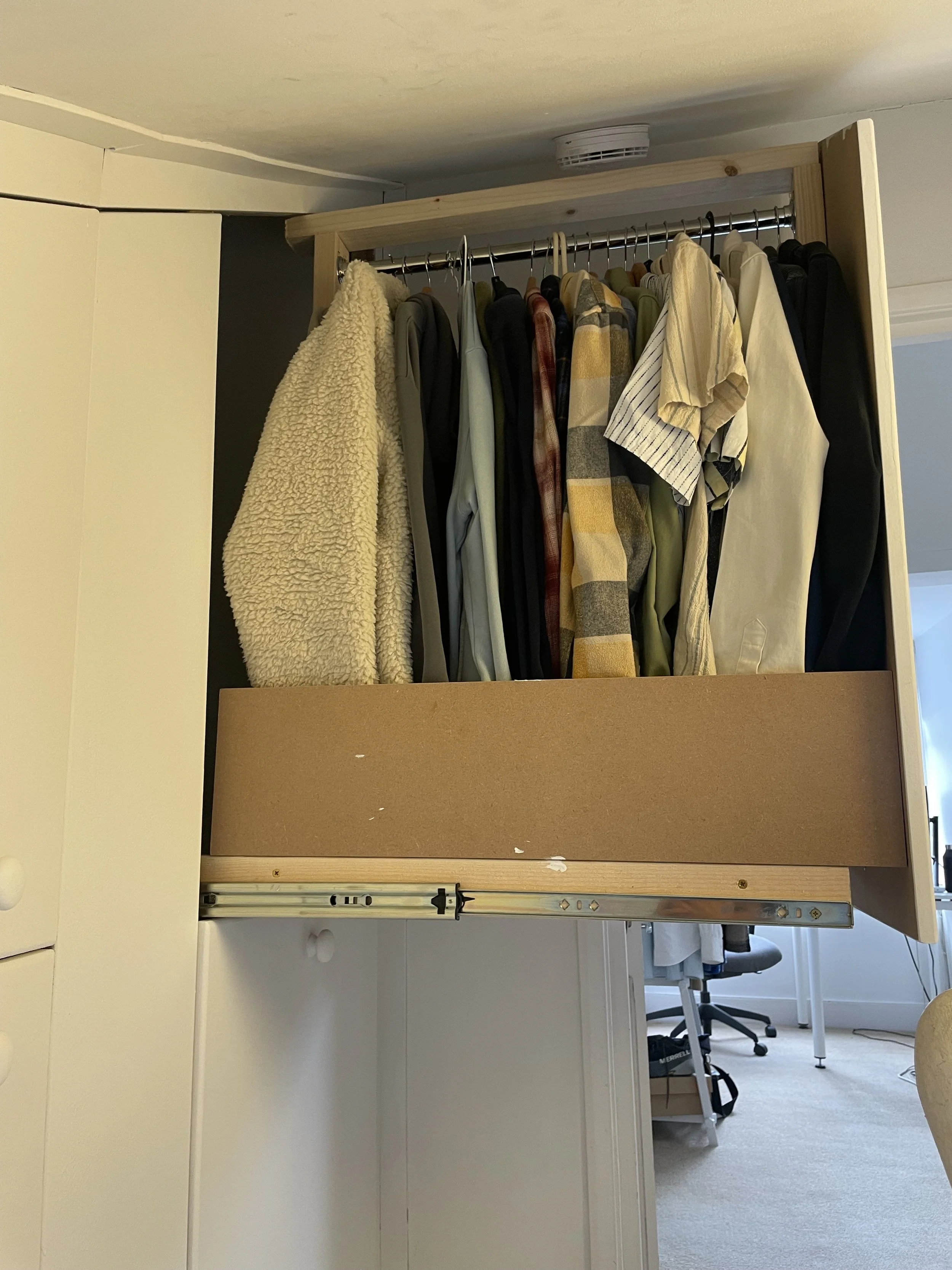 Pullout wardrobe with various clothes hanging