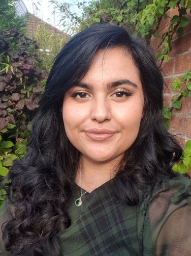 An Asian woman with long dark hair in soft curls