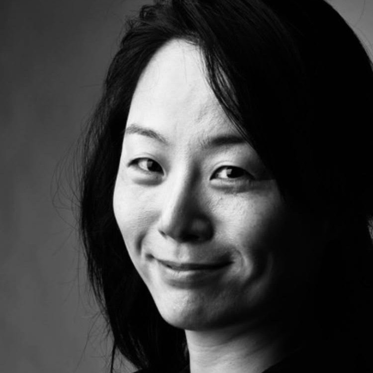 Black and white headshot of smiling South East Asian woman