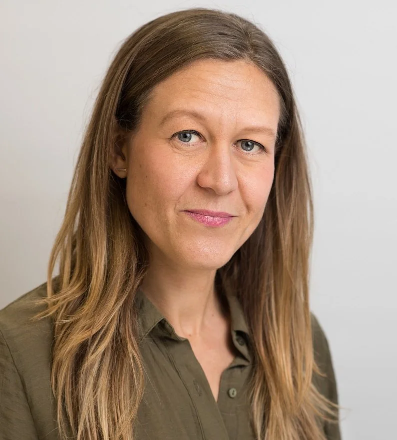 A white woman with long straight fair hair