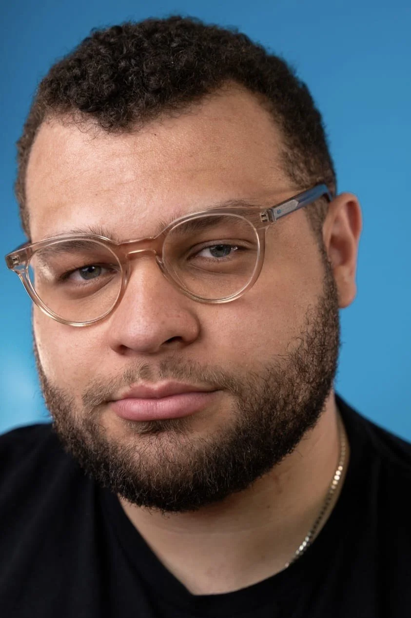 A man with close cropped dark beard and hair