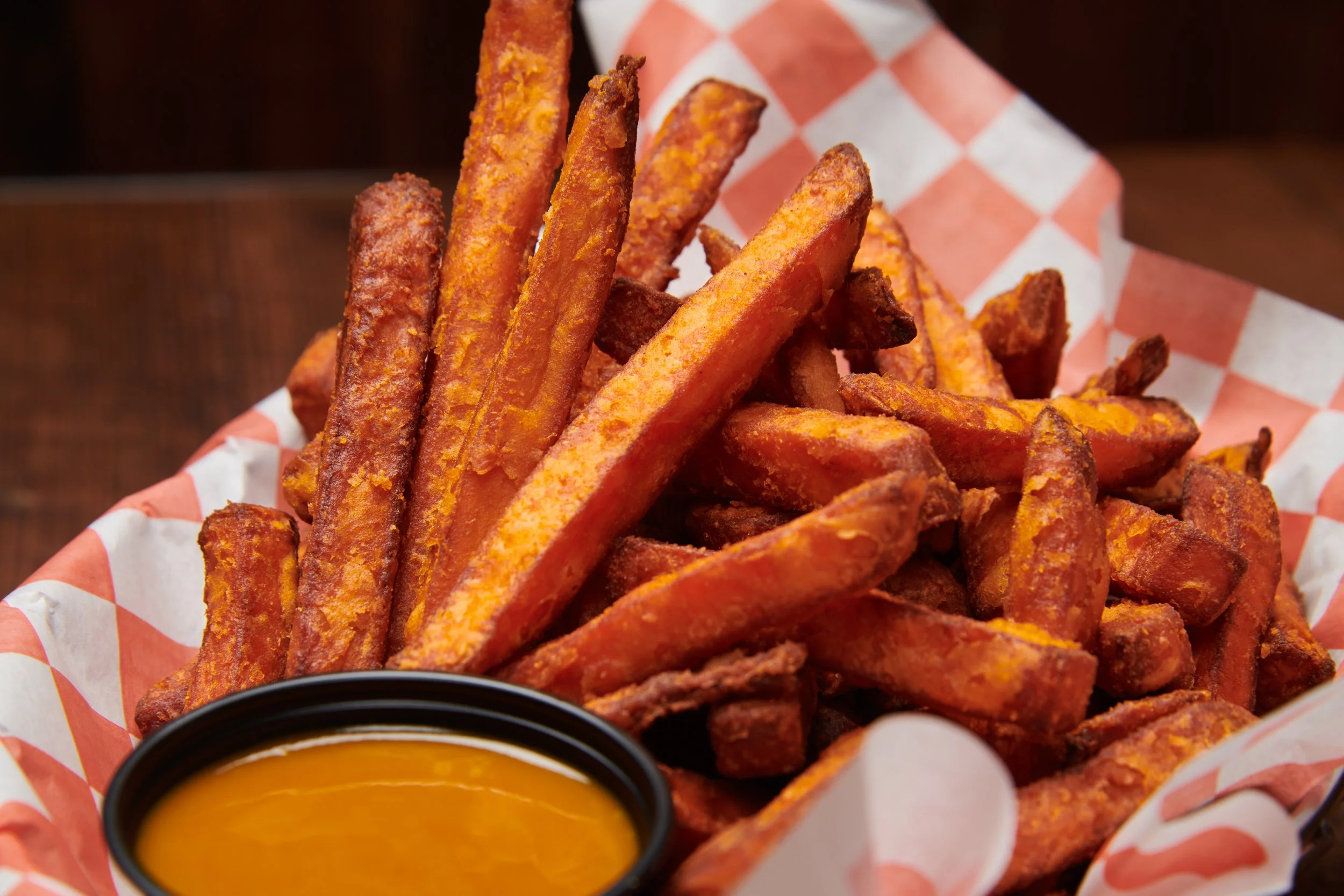Basket of sweet potato fries with dipping sauce