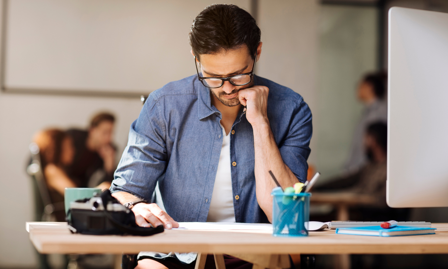 A man sitting at a table hyperfocusing on a tasks