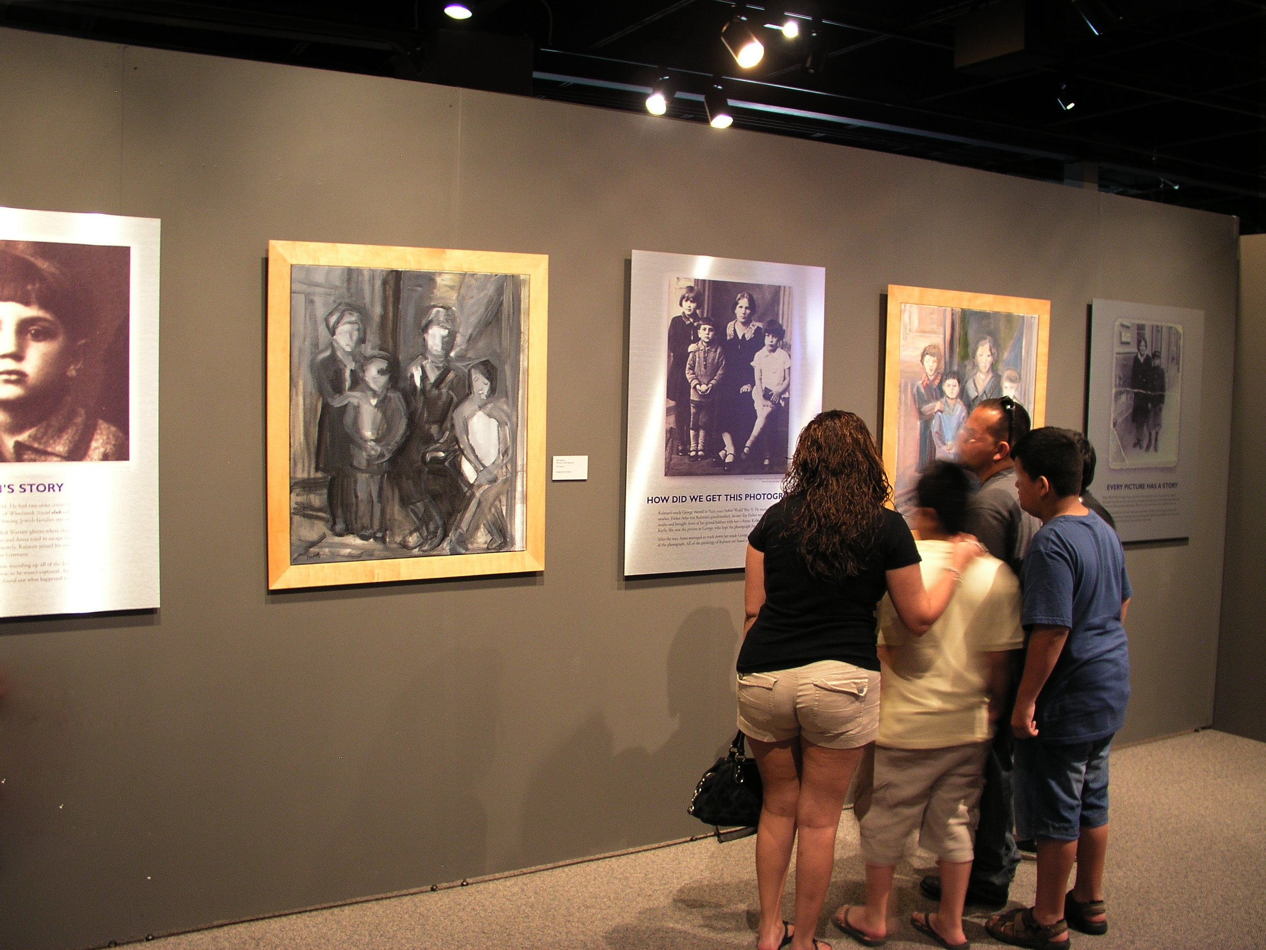 Houston Family in front of paintings and panels.jpg