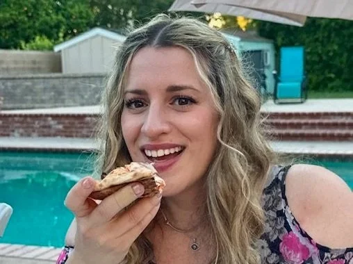 happy guest enjoying mortadella and burrata pizza at an Italian catering event in Los Angeles