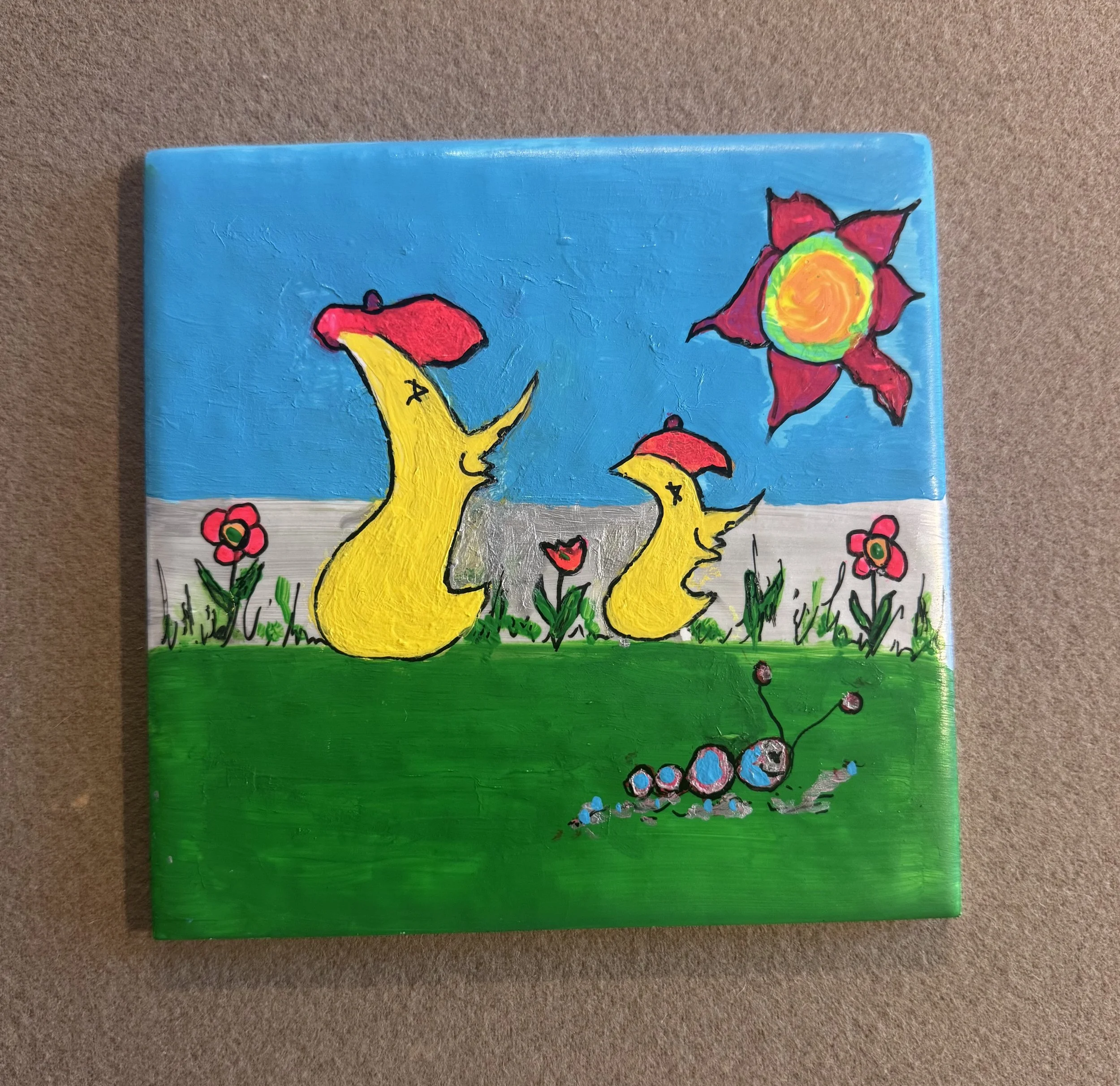 Fun in the Sun. Moongoons painted on tile.