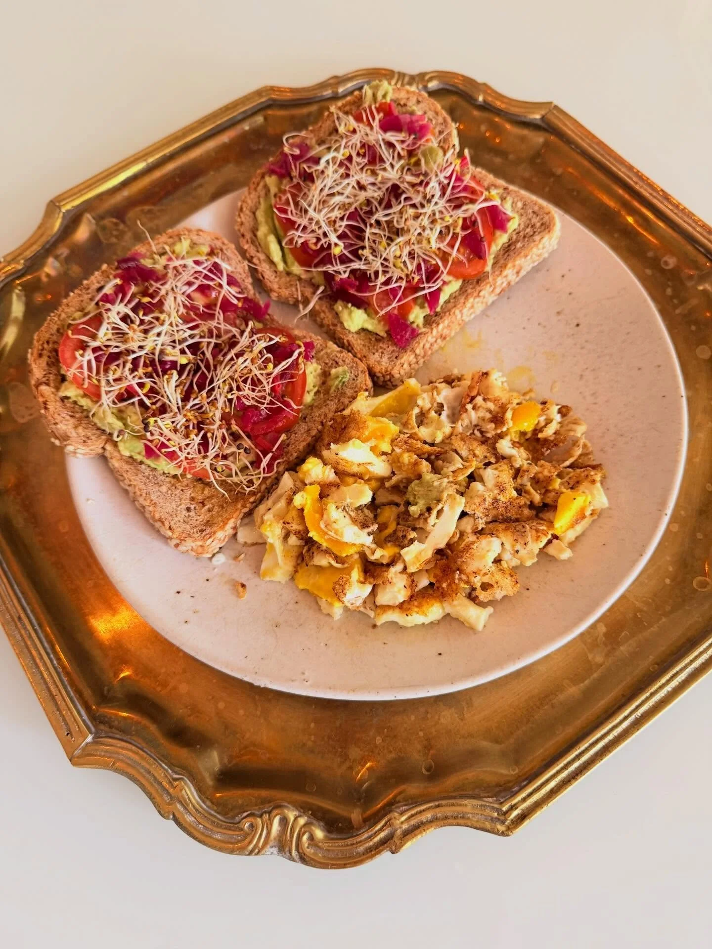 my current obsession: 
toasted buttered sesame @foodforlifebaking (10g protein) &bull; smashed avocado &bull; campari tomato &bull; salt &bull; broccoli kale alfalfa sprouts &bull; @clevelandkitchen beet kraut &bull; topped with 2 over medium fried e